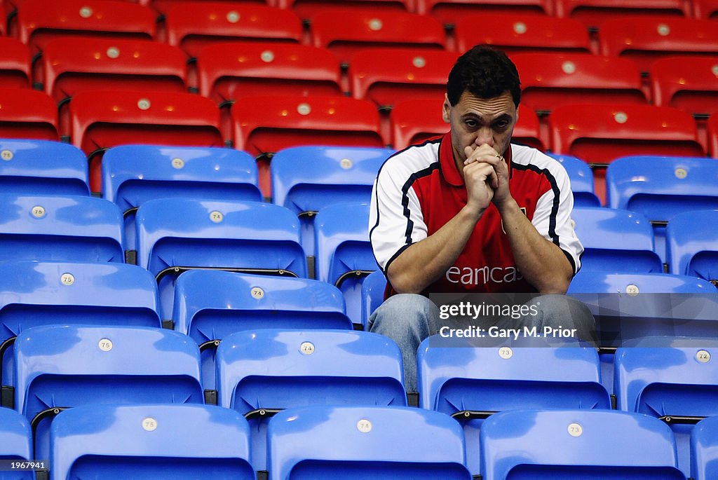 An Arsenal fan looks dejected 