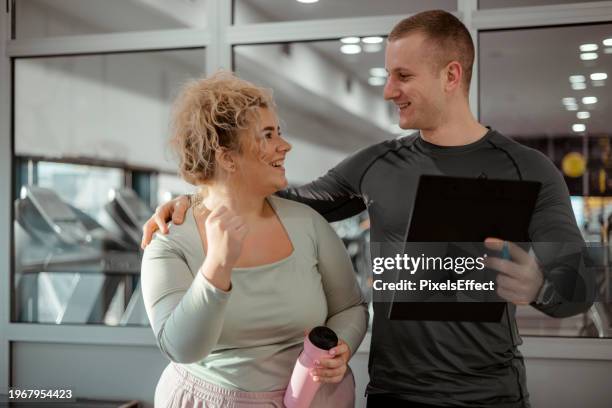 happy plus size woman talking to fitness instructor - obesity trainer stock pictures, royalty-free photos & images