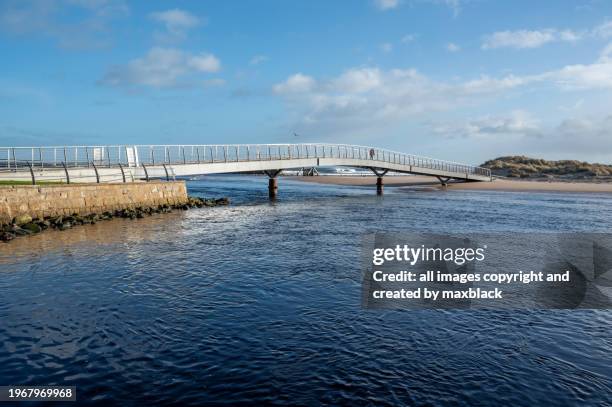 high tide in winter at lossiemouth bridge. - steel railings stock pictures, royalty-free photos & images