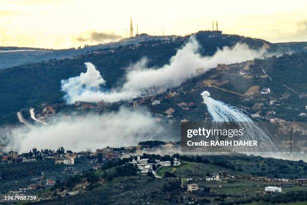 Smoke billows during Israeli shelling on the southern Lebanese village of Kfar Kila near the border with Israel on January 31 amid ongoing...