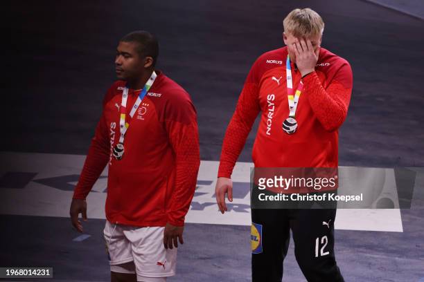 Mads Mensah Larsen and Emil Nielsen of Denmark look dejected with their silver medals after the Men's EHF Euro 2024 final match between Denmark and...