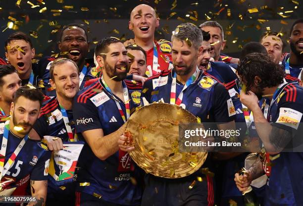 Nikola Karabatic and Luka Karabatic of France celebrate with the trophy after winning the Men's EHF Euro 2024 at Lanxess Arena on January 28, 2024 in...
