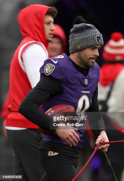 Justin Tucker of the Baltimore Ravens warms up in front of Patrick Mahomes of the Kansas City Chiefs prior to the AFC Championship Game against the...