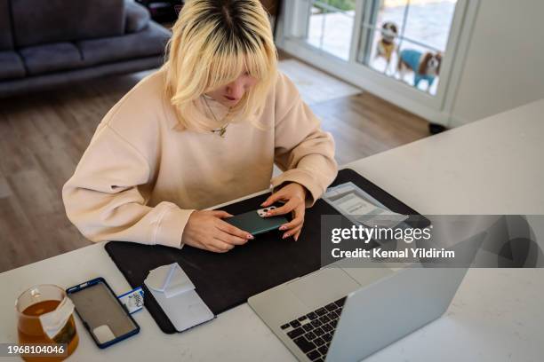 millennial girl changing mobile phone screen protector - lifehack stock pictures, royalty-free photos & images