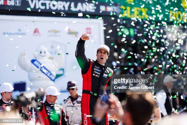 Felipe Nasr driver of the Porsche Penske Motorsport Porsche 963 celebrates in victory lane with his team after winning the Rolex 24 at Daytona...