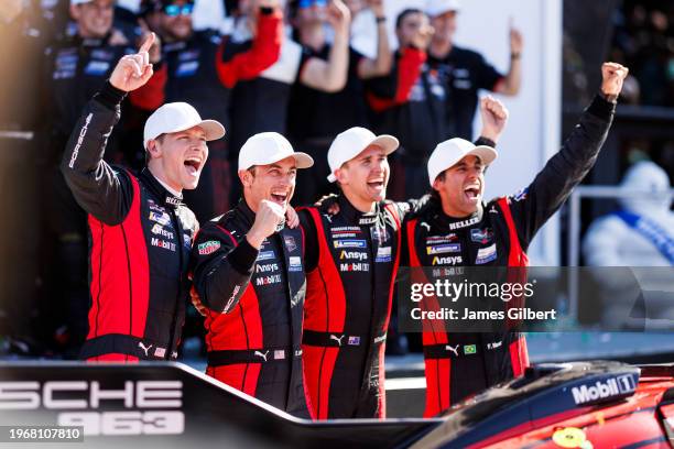 The Porsche Penske Motorsport Porsche 963 team of Dane Cameron, Felipe Nasr, Matt Campbell and Josef Newgarden celebrate In victory lane after...