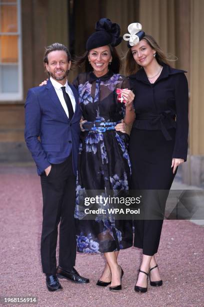 Davina McCall with her partner Michael Douglas and her daughter Holly Robertson after being made an MBE, Member of the Order of the British Empire,...