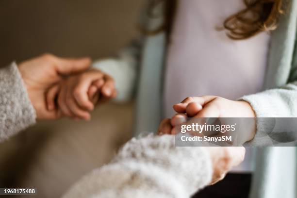 unrecognizable people holding hands - unrecognisable person stock pictures, royalty-free photos & images