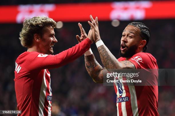 Memphis Depay of Atletico Madrid celebrates scoring his team's second goal with teammate Antoine Griezmann during the LaLiga EA Sports match between...