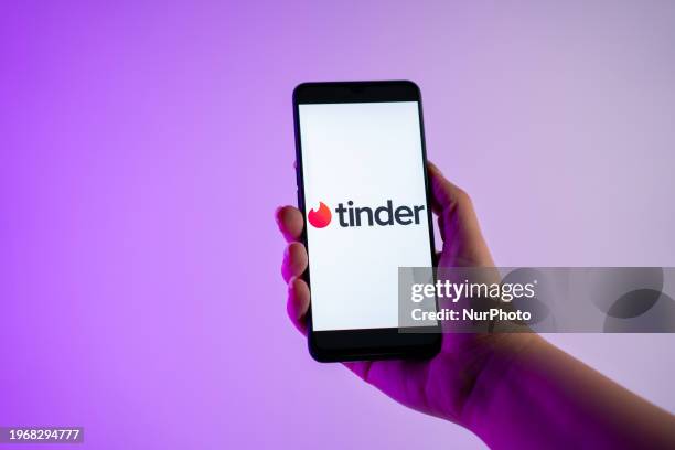 Person is holding a mobile phone with the Tinder dating app logo on its screen, in Athens, Greece, on 31 January 2024.