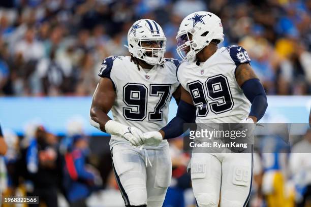 Osa Odighizuwa of the Dallas Cowboys celebrates with Chauncey Golston of the Dallas Cowboys after a play during an NFL football game against the Los...