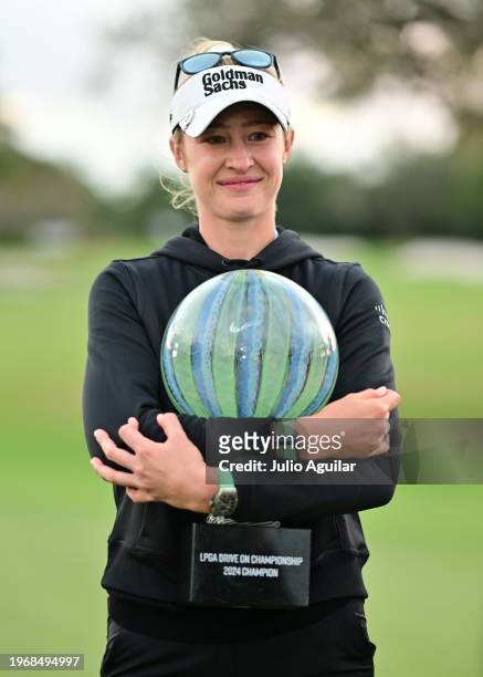 Nelly Korda of the United States holds the championship trophy after a victory on the second play-off hole during the final round of the LPGA Drive...