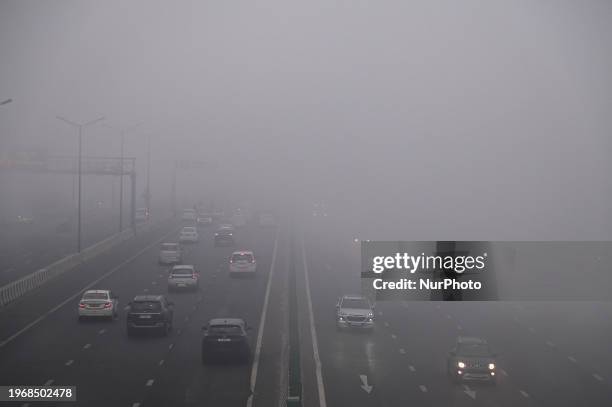 Traffic is passing through a highway amidst dense fog in New Delhi, India, on January 31, 2024.