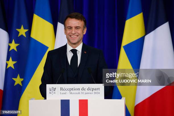 French President Emmanuel Macron reacts as he delivers his last speech at the farewell reception hosted by the French presidential couple in honor of...