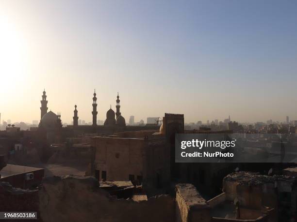 The Sultan Hassan Mosque and Al-Rifai Mosque stand next to ancient houses.