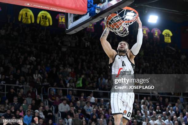 Bologna's French guard Isaia Cordinier scores a dunk during the Euroleague round 24 basketball match between FC Barcelona and Virtus Bologna at the...