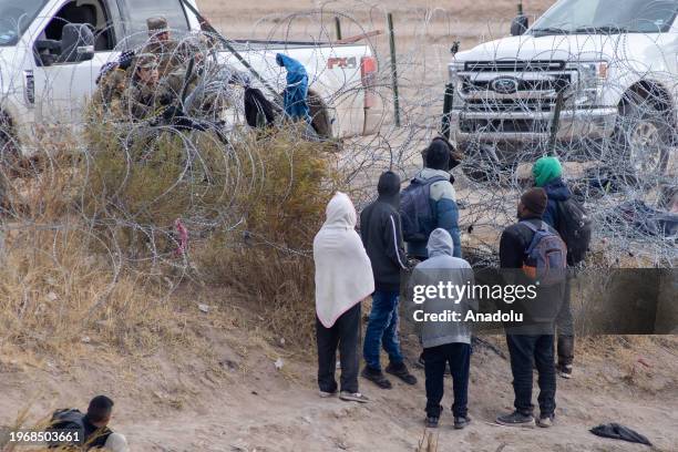 Group of migrants from different nationalities attempt to cross Mexico-United States border along razor wire despite heightened security measures, in...