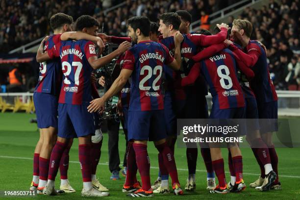 Barcelona players celebrate the opening goal scored by Barcelona's Brazilian forward Vitor Roque during the Spanish league football match between FC...