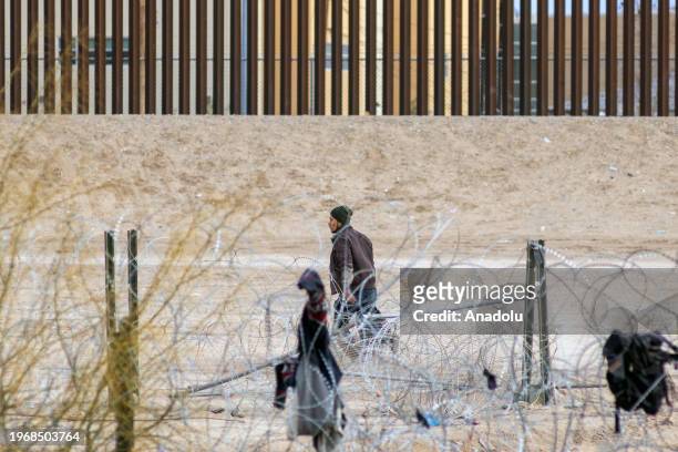 Group of migrants from different nationalities attempt to cross Mexico-United States border along razor wire despite heightened security measures, in...
