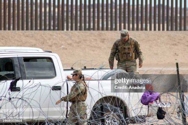 Border police patrol along the fenced border as a group of migrants from different nationalities attempt to cross Mexico-United States border along...