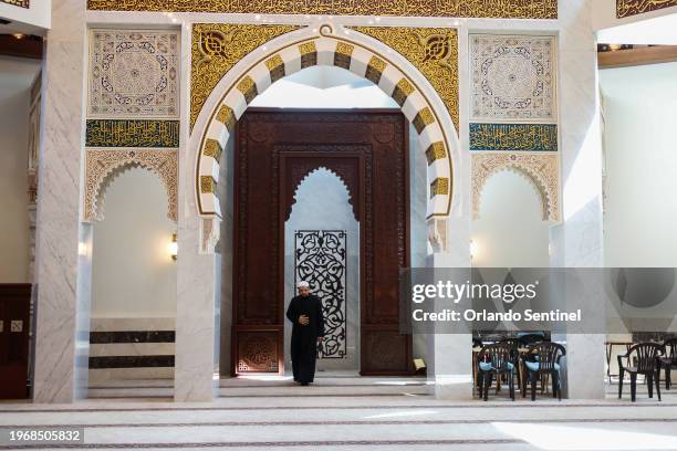 Imam Mujtaba Khaliq leads midday prayers walks inside a the main prayer room, on Nov. 1 in Sanford, Florida.