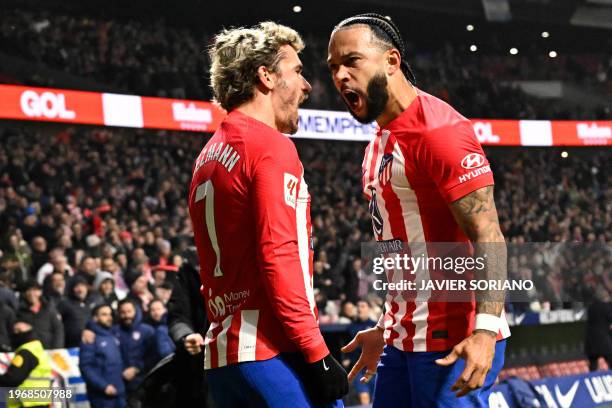 Atletico Madrid's Dutch forward Memphis Depay celebrates scoring his team's second goal, with Atletico Madrid's French forward Antoine Griezmann,...