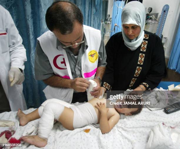 Wounded Palestinian baby receives first aid at Ramallah hospital after an explosion rocked al-Amari refugee camp, killing two Palestinians, including...