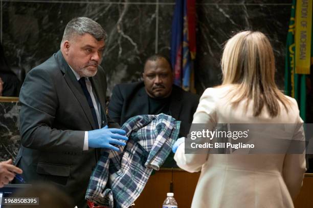 William Creek , a Forensic Technician with the Detroit Police Department, is shown evidence as he testifies at the trial of Jennifer Crumbley, the...