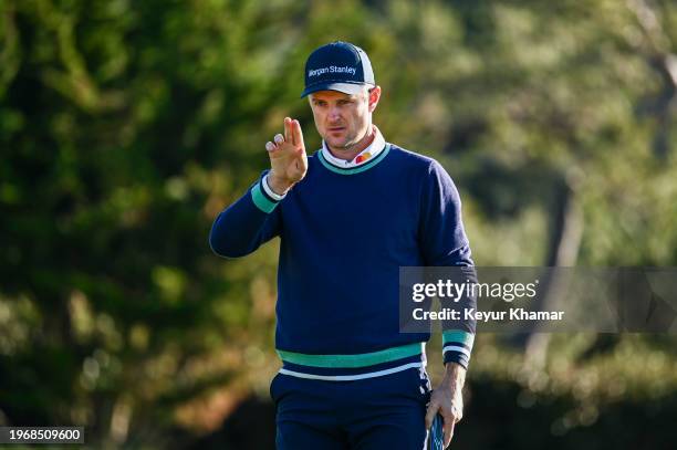 Justin Rose of England uses AimPoint to read his birdie putt on the 13th hole green, a putt which he made, during the continuation of the final round...