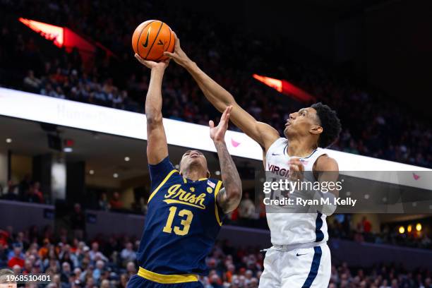 Ryan Dunn of the Virginia Cavaliers blocks a shot by Tae Davis of the Notre Dame Fighting Irish in the first half at John Paul Jones Arena on January...