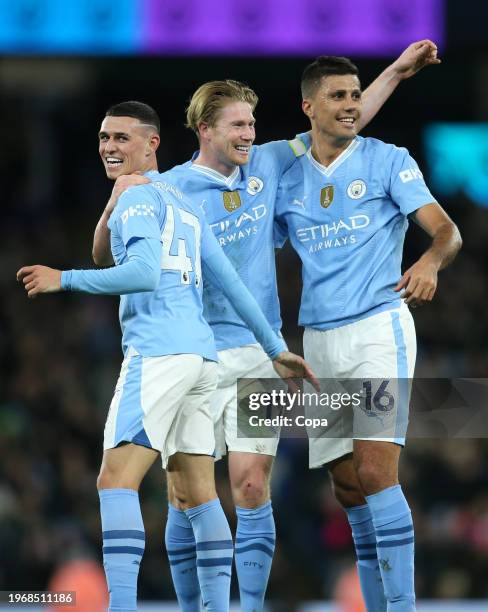 Kevin De Bruyne, Phil Foden and Rodri of Manchester City celebrate their team's second goal scored by Julian Alvarez during the Premier League match...