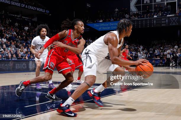 St. John's Red Storm guard Daniss Jenkins defends against Xavier Musketeers guard Quincy Olivari during a college basketball game on January 31, 2024...