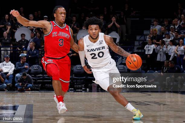 Xavier Musketeers guard Dayvion McKnight brings the ball up court while defended by St. John's Red Storm guard Jordan Dingle during a college...