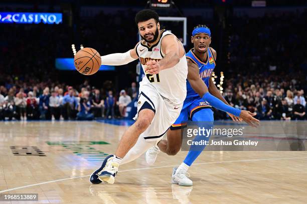 Jamal Murray of the Denver Nuggets drives against Shai Gilgeous-Alexander of the Oklahoma City Thunder during the second half at Paycom Center on...