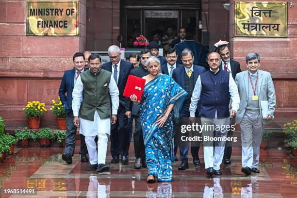 Nirmala Sitharaman, India's finance minister, center, and other members of the finance ministry leave the ministry to present the budget at the...