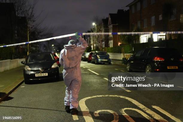 Police at the scene in Lessar Avenue near Clapham Common, south London, where a woman and her two young children have been taken to hospital after a...