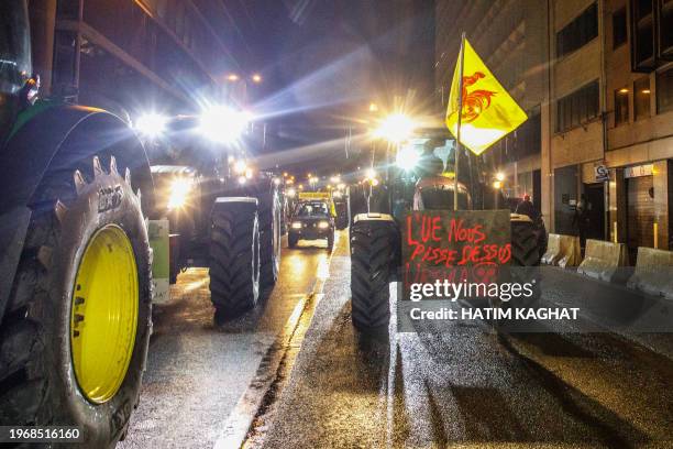 Farmers with tractors take part in a protest action in the European district in Brussels, organized by general farmers union ABS to demand better...