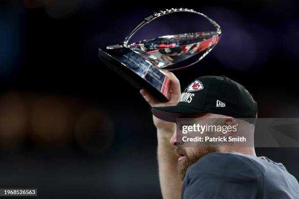 Travis Kelce of the Kansas City Chiefs celebrates with the Lamar Hunt Trophy after a 17-10 victory against the Baltimore Ravens in the AFC...