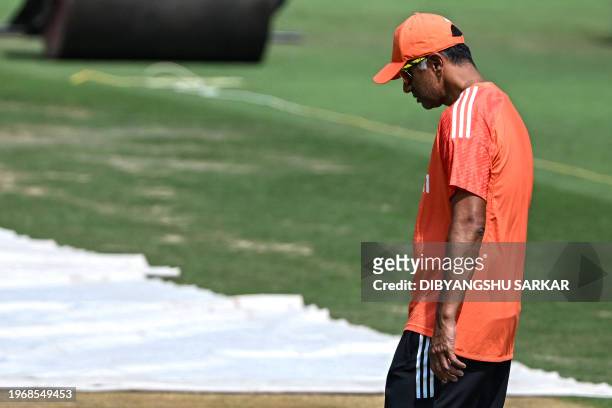 India's head coach Rahul Dravid inspects the pitch during a practice session at the Y.S. Rajasekhara Reddy Cricket Stadium in Visakhapatnam on...