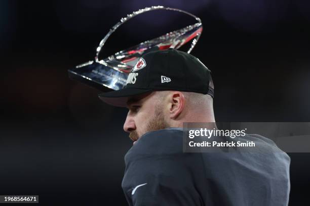 Travis Kelce of the Kansas City Chiefs celebrates with the Lamar Hunt Trophy after a 17-10 victory against the Baltimore Ravens in the AFC...