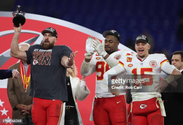 Travis Kelce of the Kansas City Chiefs celebrates with the Lamar Hunt Trophy after a 17-10 victory against the Baltimore Ravens in the AFC...