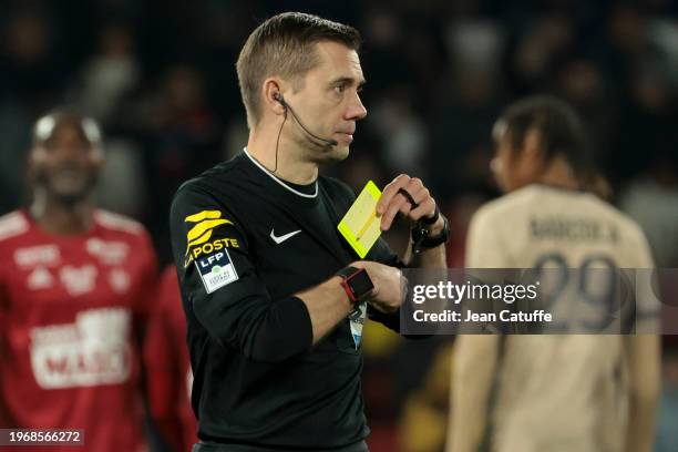 Referee Clement Turpin gives a yellow card during the Ligue 1 Uber Eats match between Paris Saint-Germain and Stade Brestois 29 at Parc des Princes...