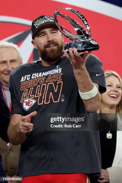 Travis Kelce of the Kansas City Chiefs celebrates with the Lamar Hunt Trophy after a 17-10 victory against the Baltimore Ravens in the AFC...