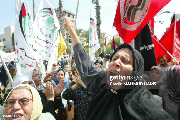 Palestinian woman shout slogans during a march to mark the third year of the intifada or uprising by Palestinians against Israeli occupation, in Gaza...