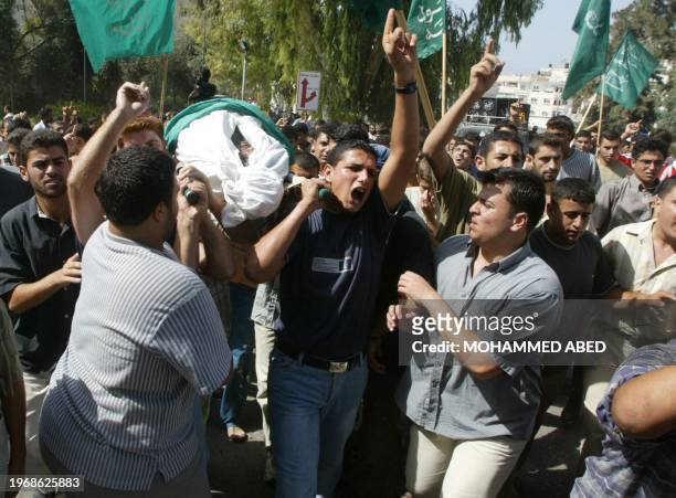 Palestinians carry the body of Ammar Abu-Wardah during his funeral procession in front of Shefa Hospital in Gaza City 10 september 2003. Abu-Wardah...