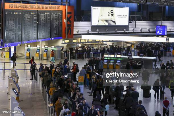 Passengers queue, during a strike by airport security workers, at Frankfurt Airport in Frankfurt, Germany, on Thursday, Feb. 1, 2024. Verdi,...