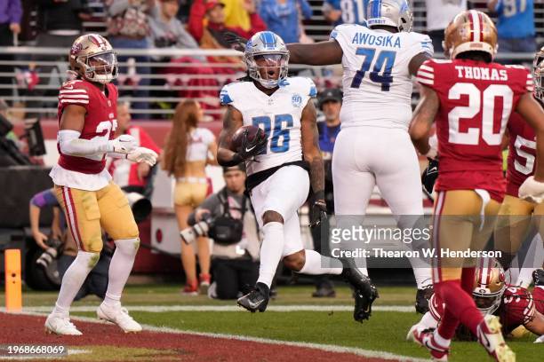 Jahmyr Gibbs of the Detroit Lions reacts as he runs the ball for a touchdown during the second quarter against the San Francisco 49ers in the NFC...