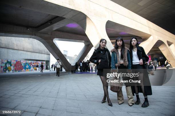 Kim Gyu-rim, far left, wears a black shearling jacket, Gwon Ji-min, center, wears a denim jacket with faux fur trims, and Kang Eun-joo, at right,...