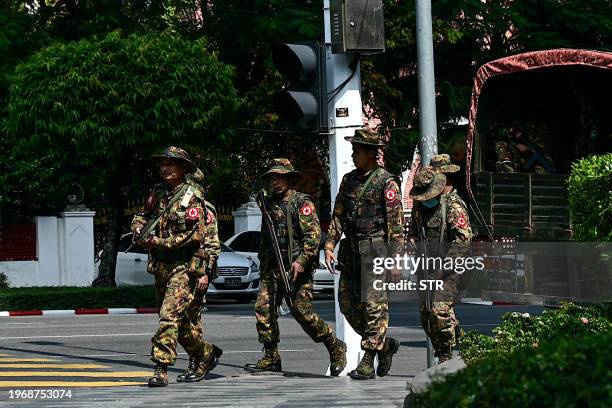 Members of the Myanmar's military security force patrol a street during a "silent strike" to protest and to mark the third anniversary of the...