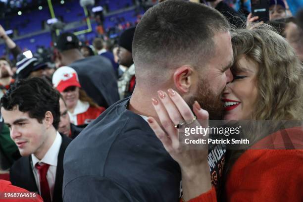 Travis Kelce of the Kansas City Chiefs embraces Taylor Swift after a 17-10 victory against the Baltimore Ravens in the AFC Championship Game at M&T...